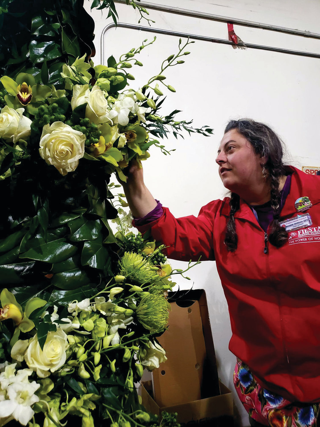 Sharrai Morgan inspects the floral arrangements of the float she and her team worked on non-stop from Dec. 26-31.